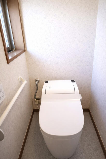 トイレ／タンクレス仕様のスタイリッシュなトイレに温水洗浄便座を備え、