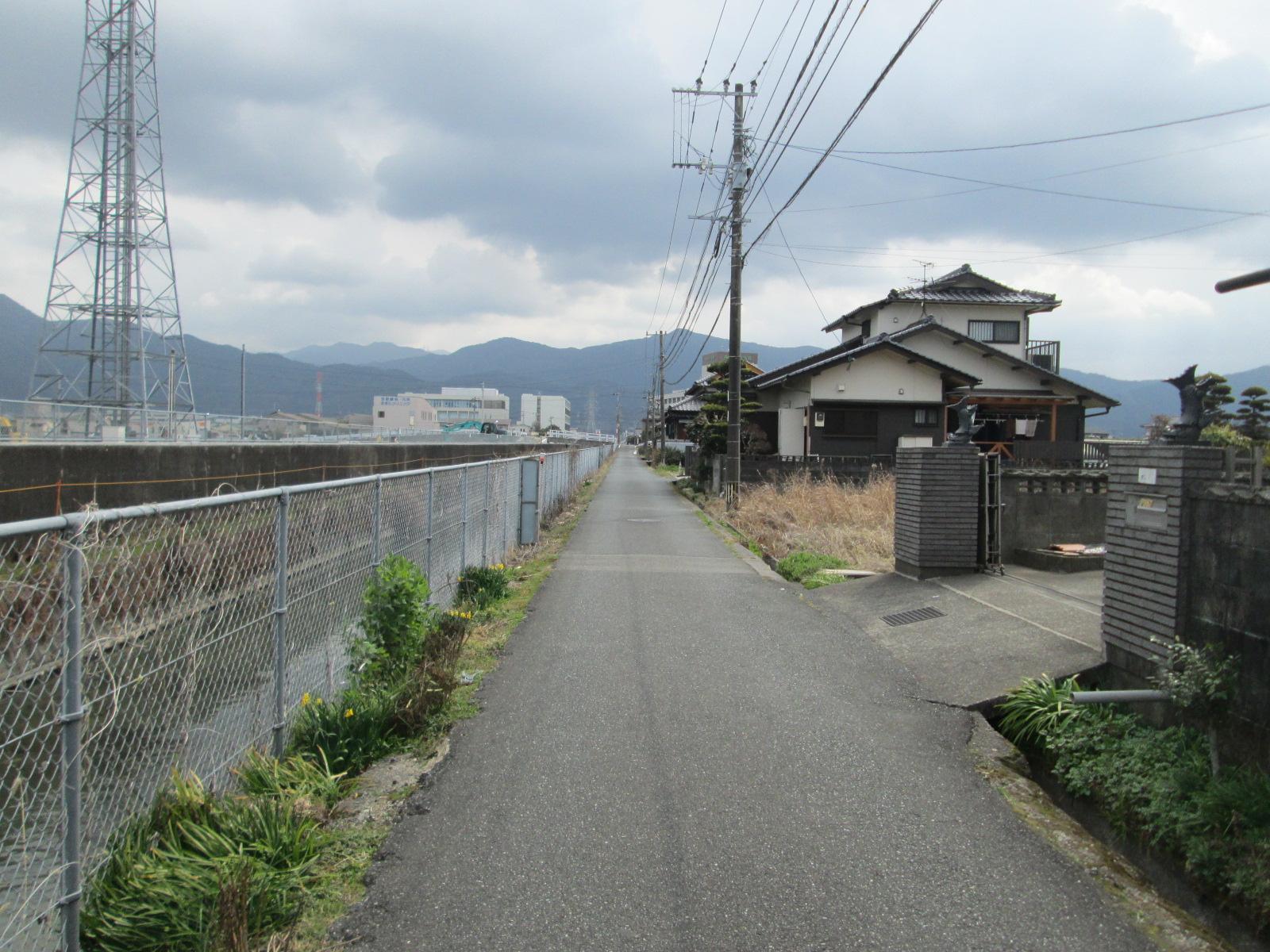現地土地（前面道路含む）／北側道路と水路を西より臨む
